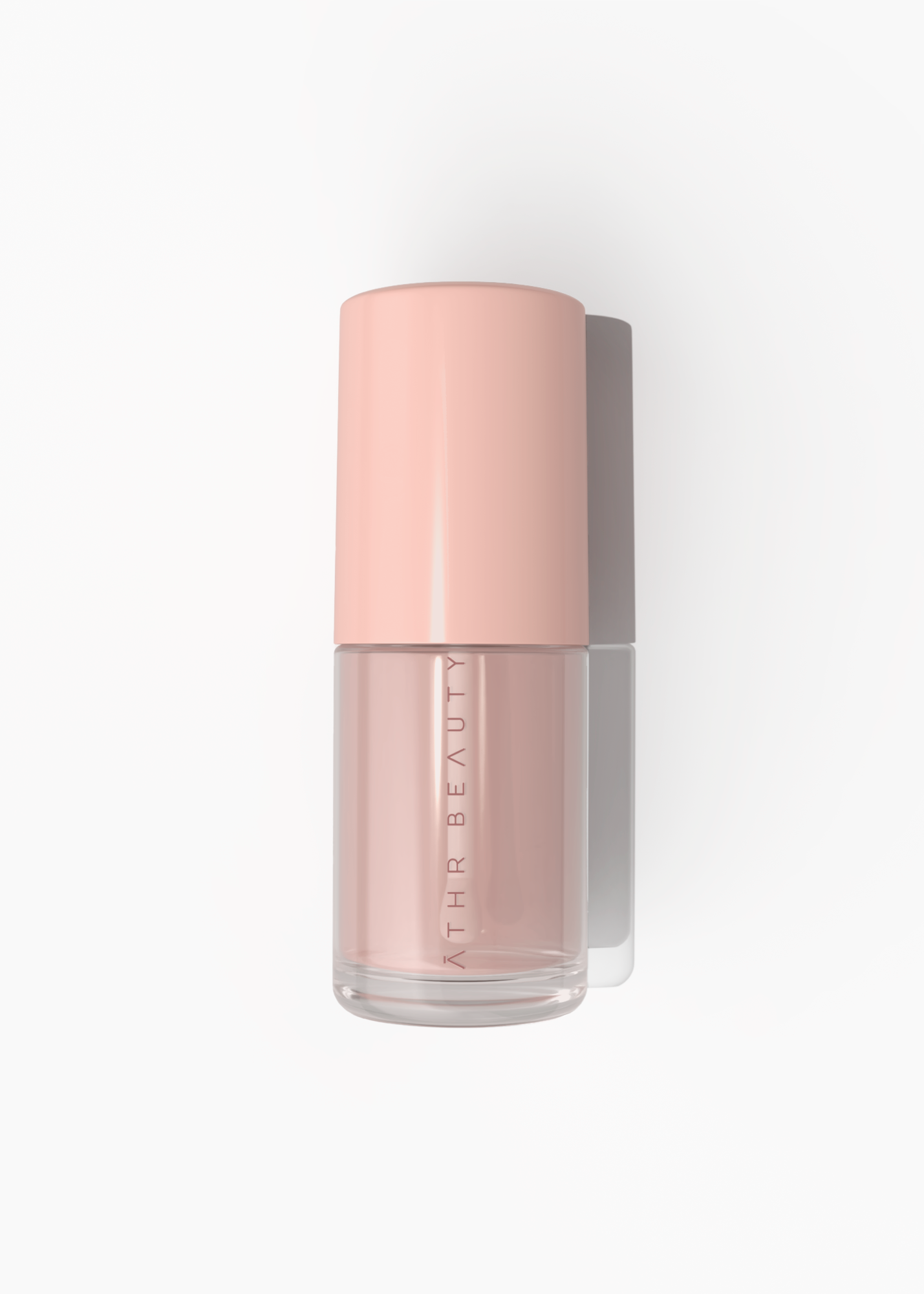Pink bottle of lip serum product with 'AthR Beauty' branding on a white background