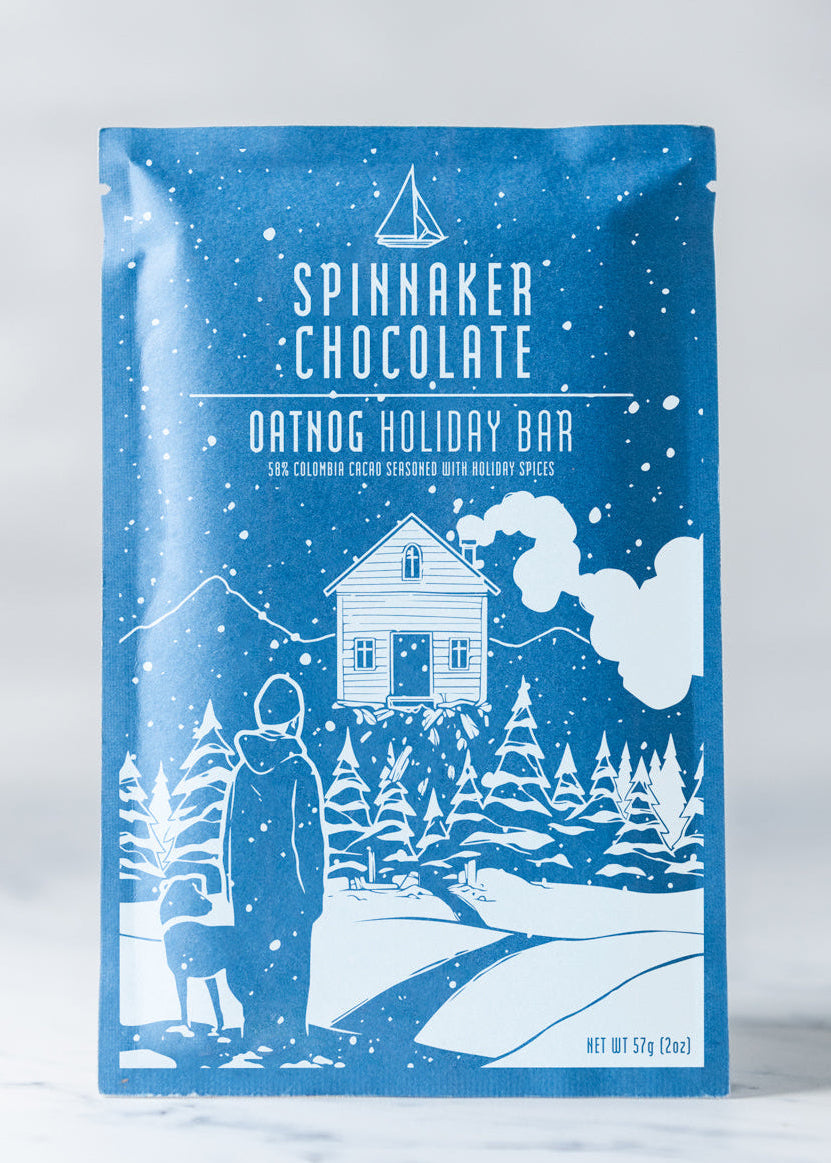 Spinnaker Chocolate Oatdog Holiday Bar packaging with winter scene illustration on a white background