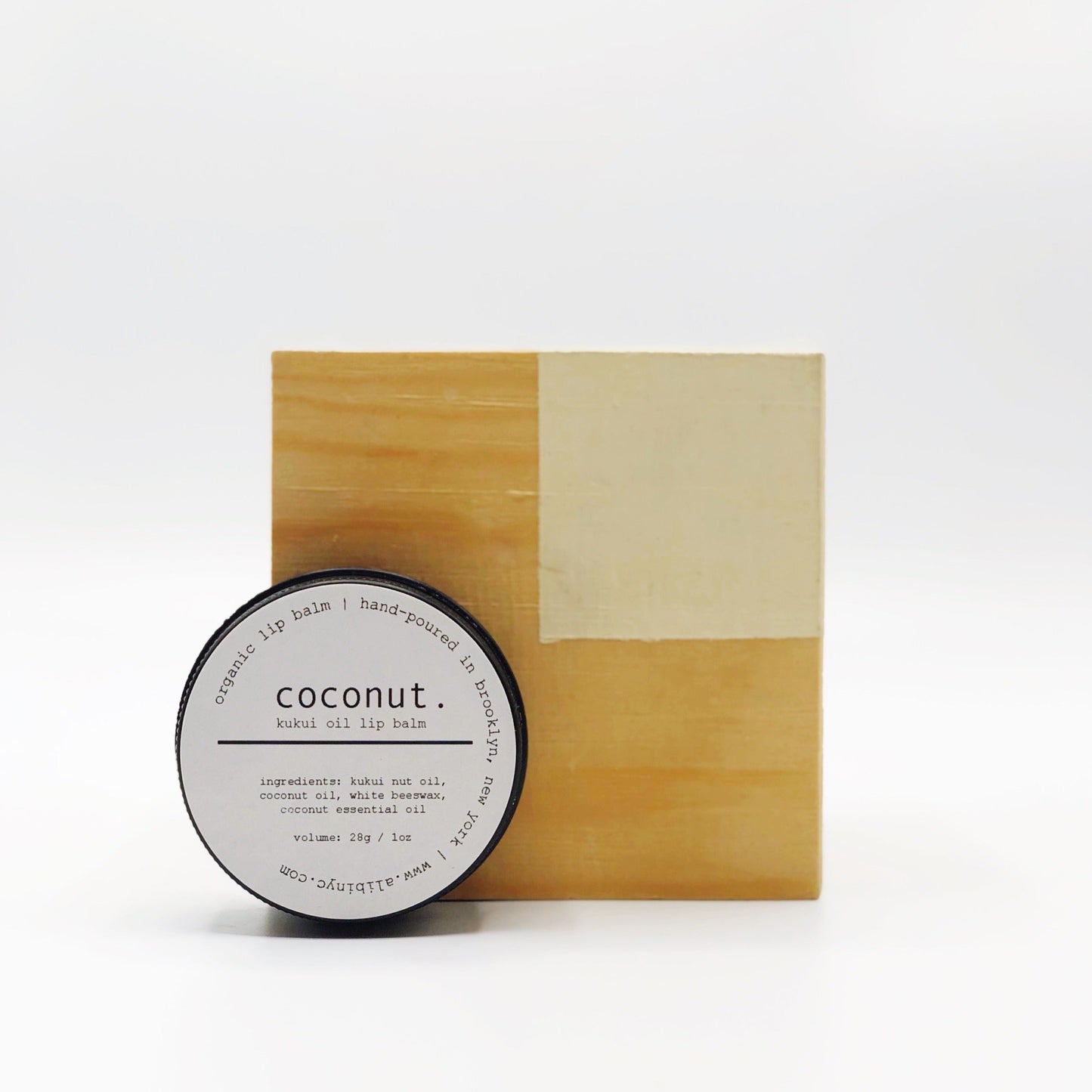 Coconut lip balm with wooden packaging on a white background
