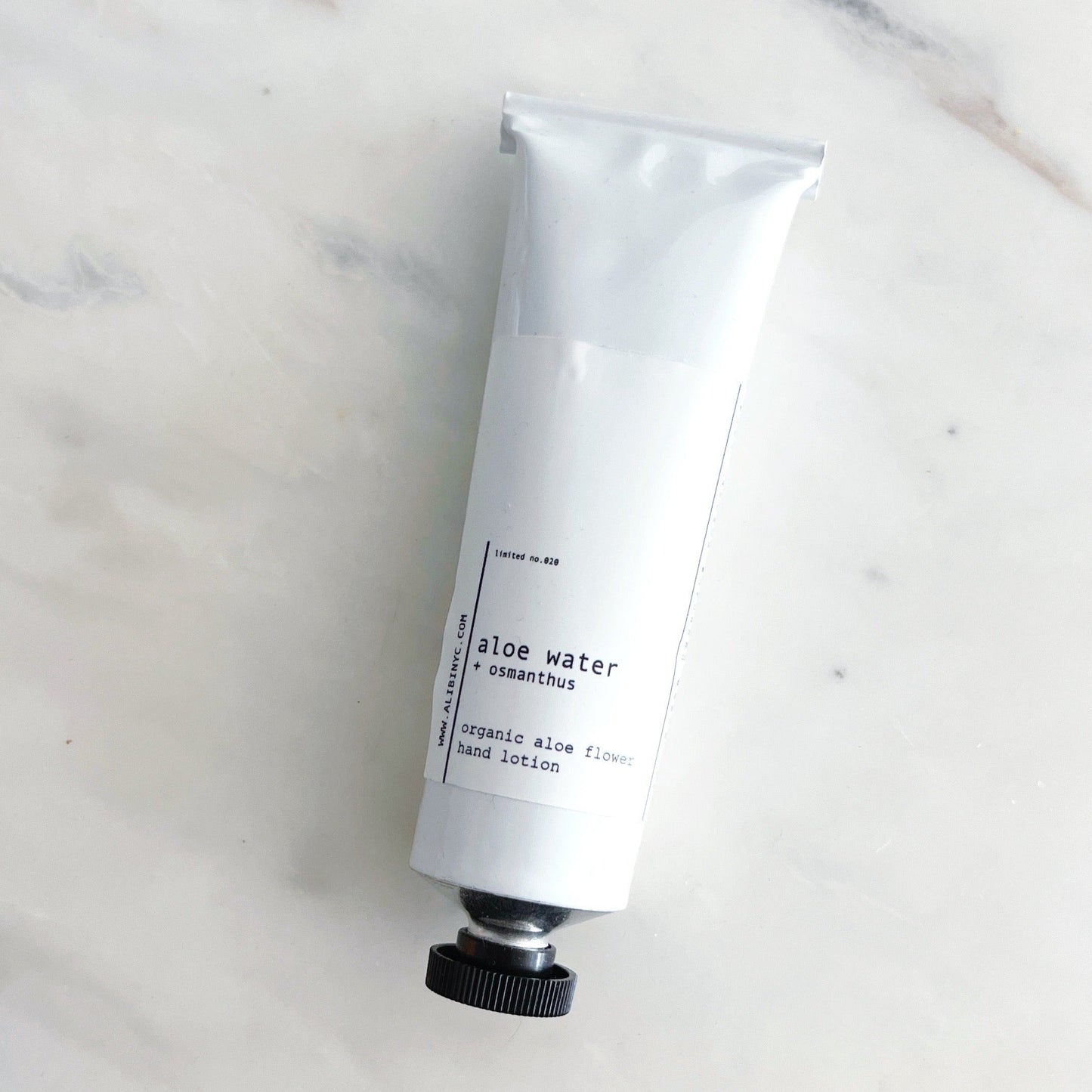 Hand cream tube on a marble surface