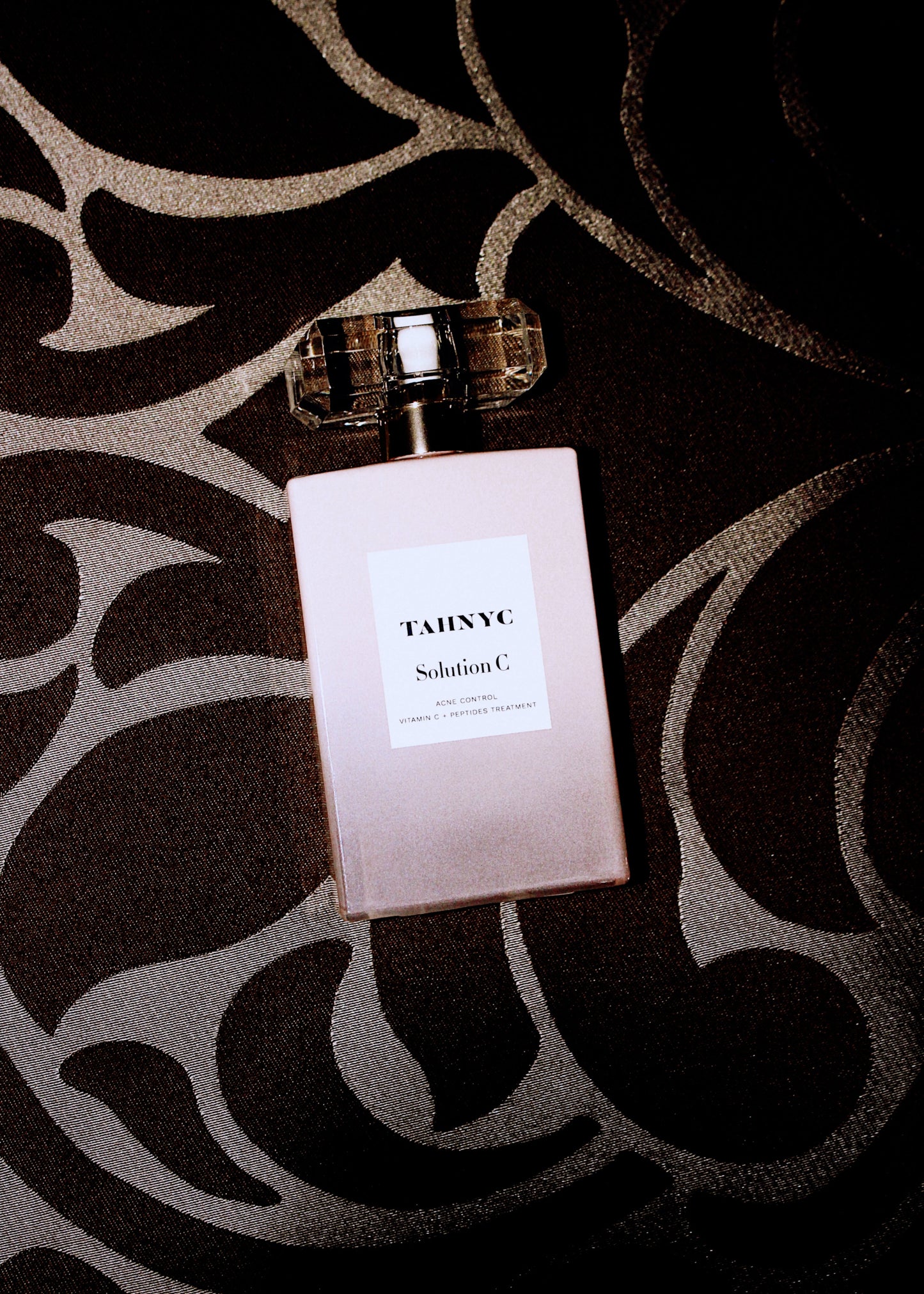 Solution C bottle with 'TAHNYC' label on a patterned surface