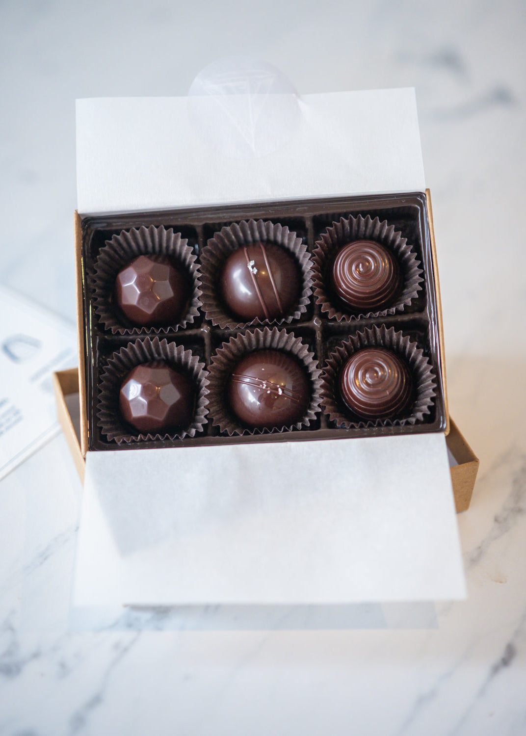 Box of chocolates on a marble surface