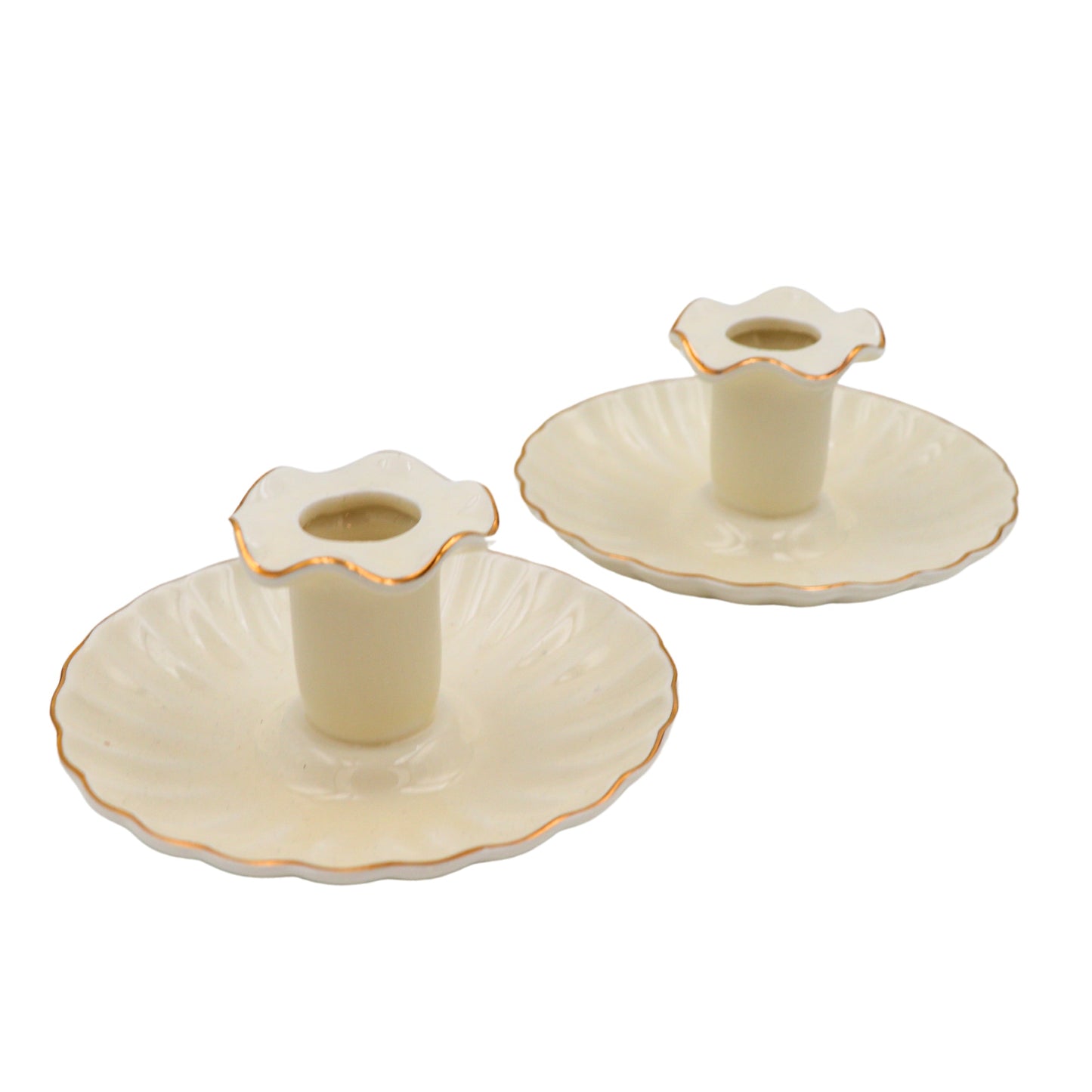 Set of three decorative candle holders with scalloped edges on a white background