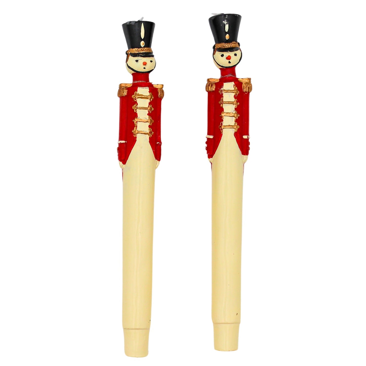 Two decorative candles with toy soldier design on a white background