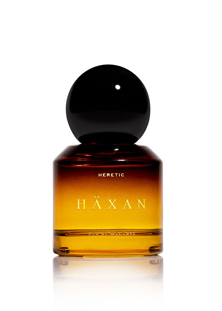 Häxan perfume bottle with black cap on a white background