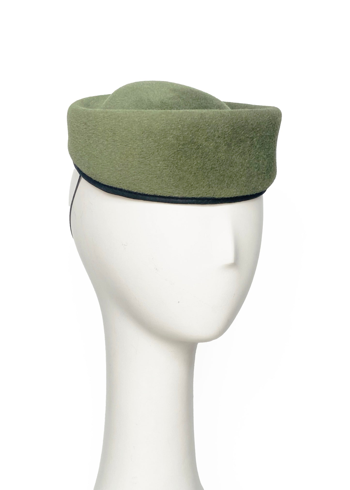 Green felt hat on a mannequin head against a white background