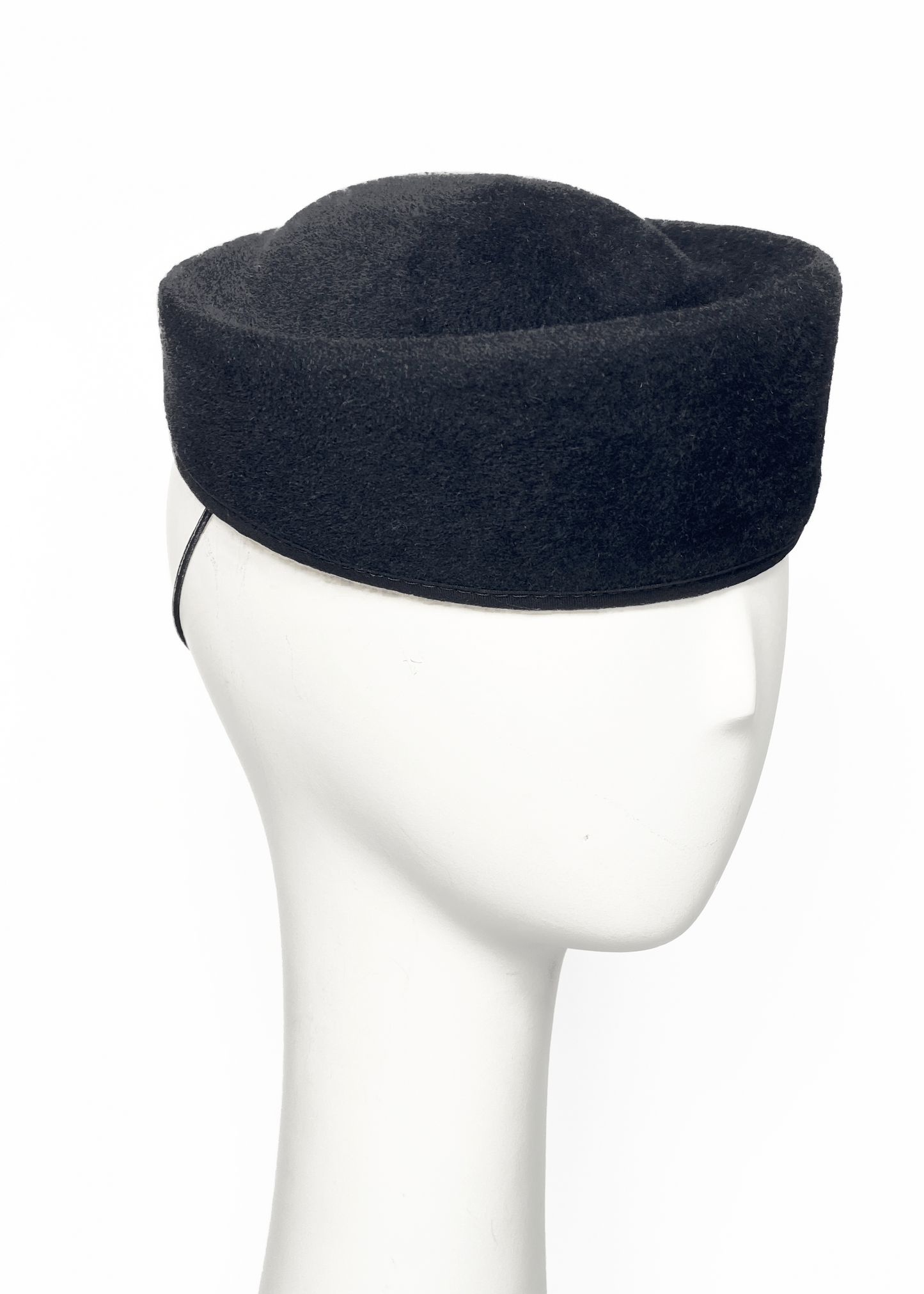 Black felt hat on a mannequin head against a white background