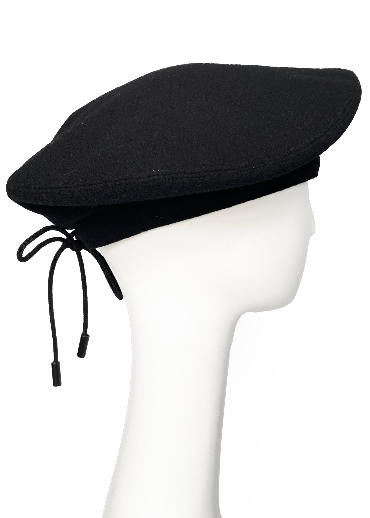Black beret on a mannequin head against a white background