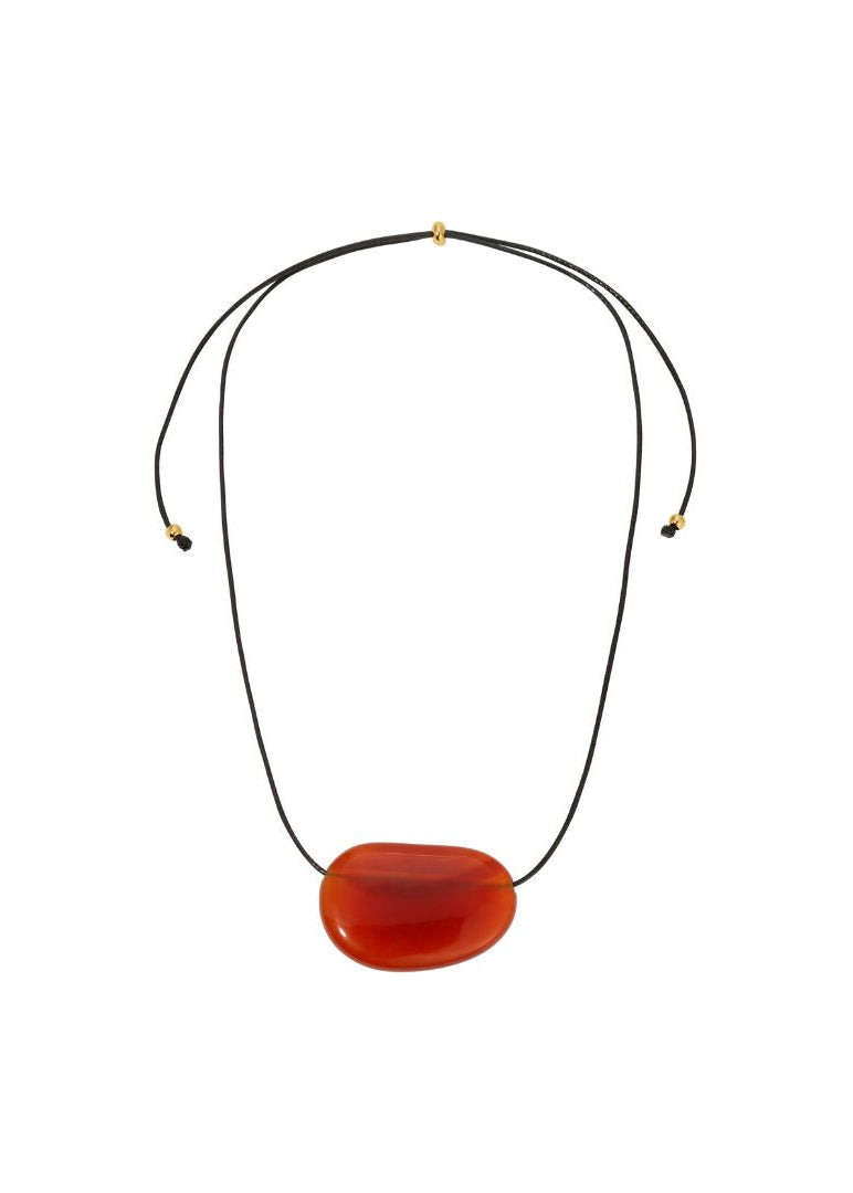 Necklace with a large red pendant on a white background
