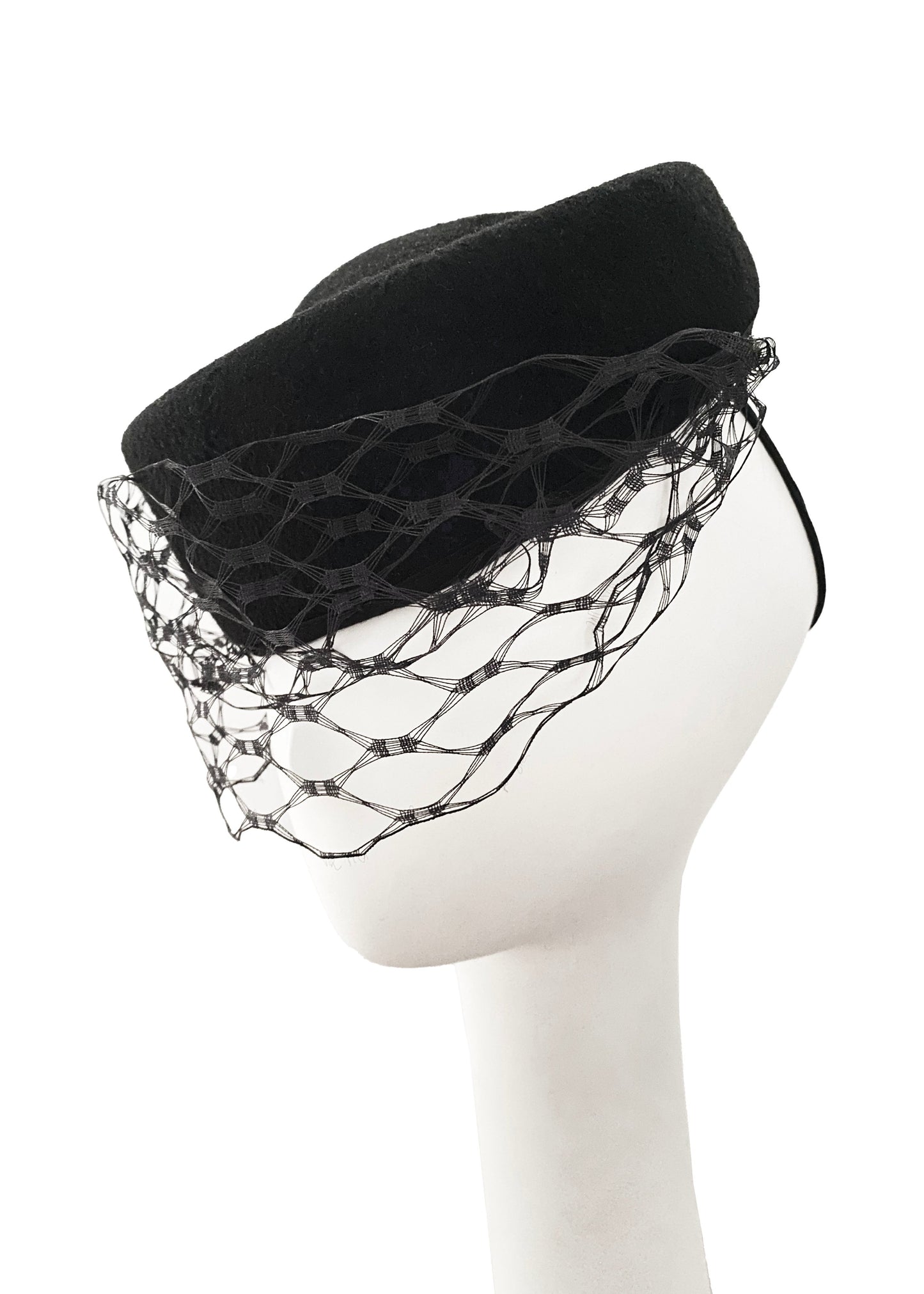 Black felt beret with a decorative black netting on a mannequin head against a white background