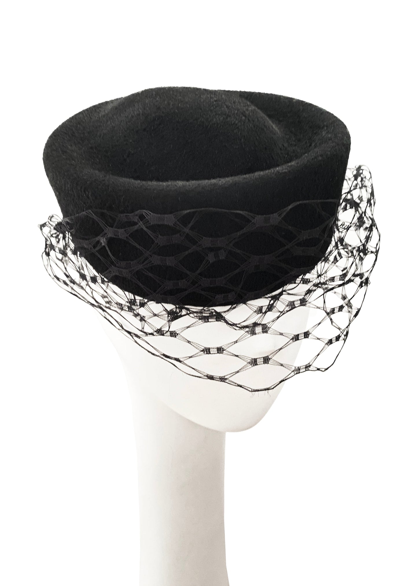 Black hat with decorative netting on a white background