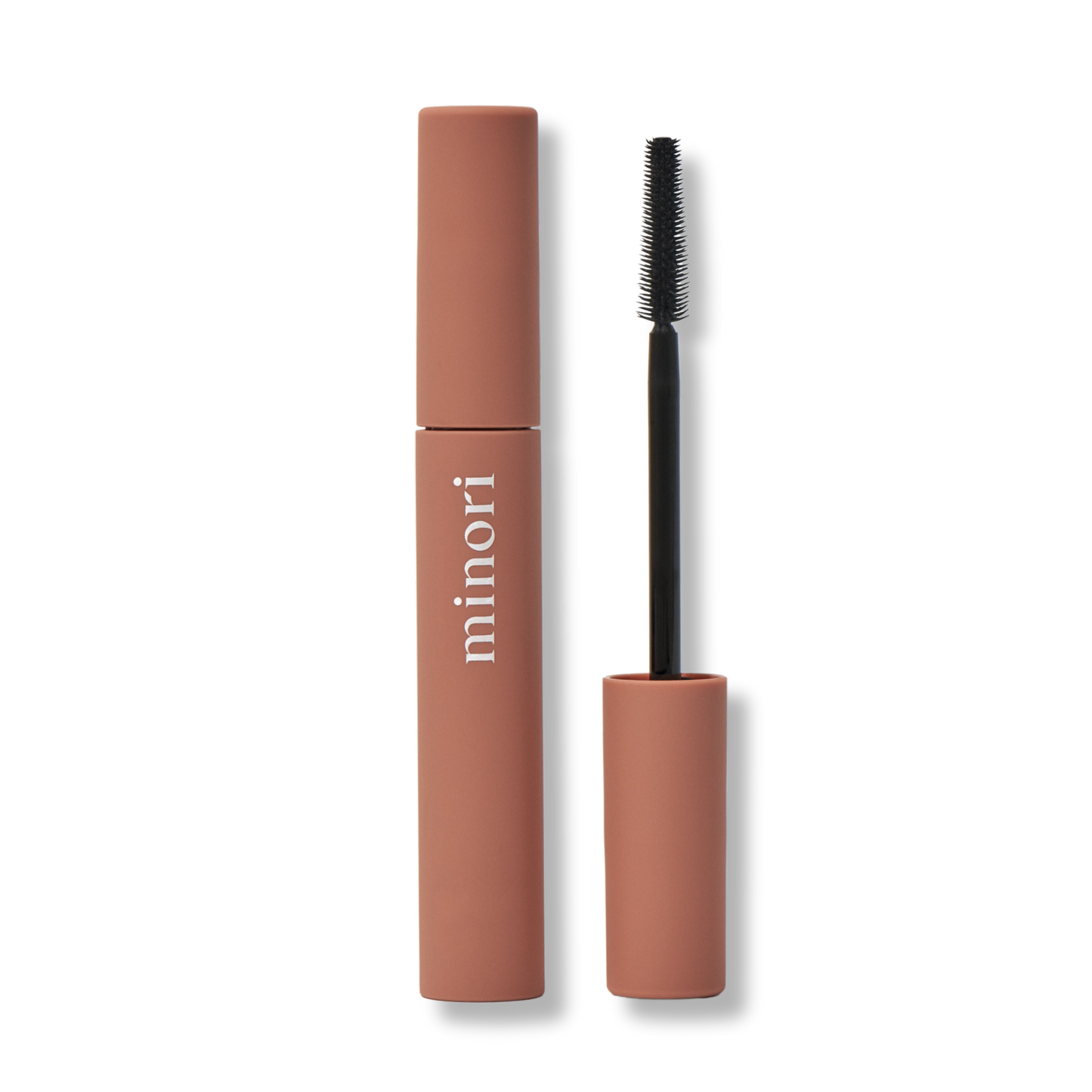 Minori mascara with brown casing and black brush on a white background