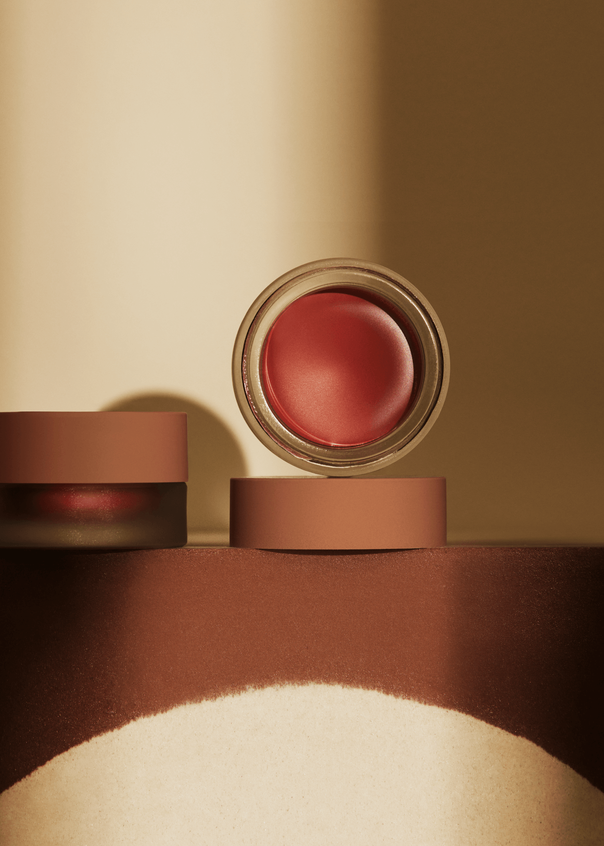 Cosmetic product with a pink shade on a brown surface