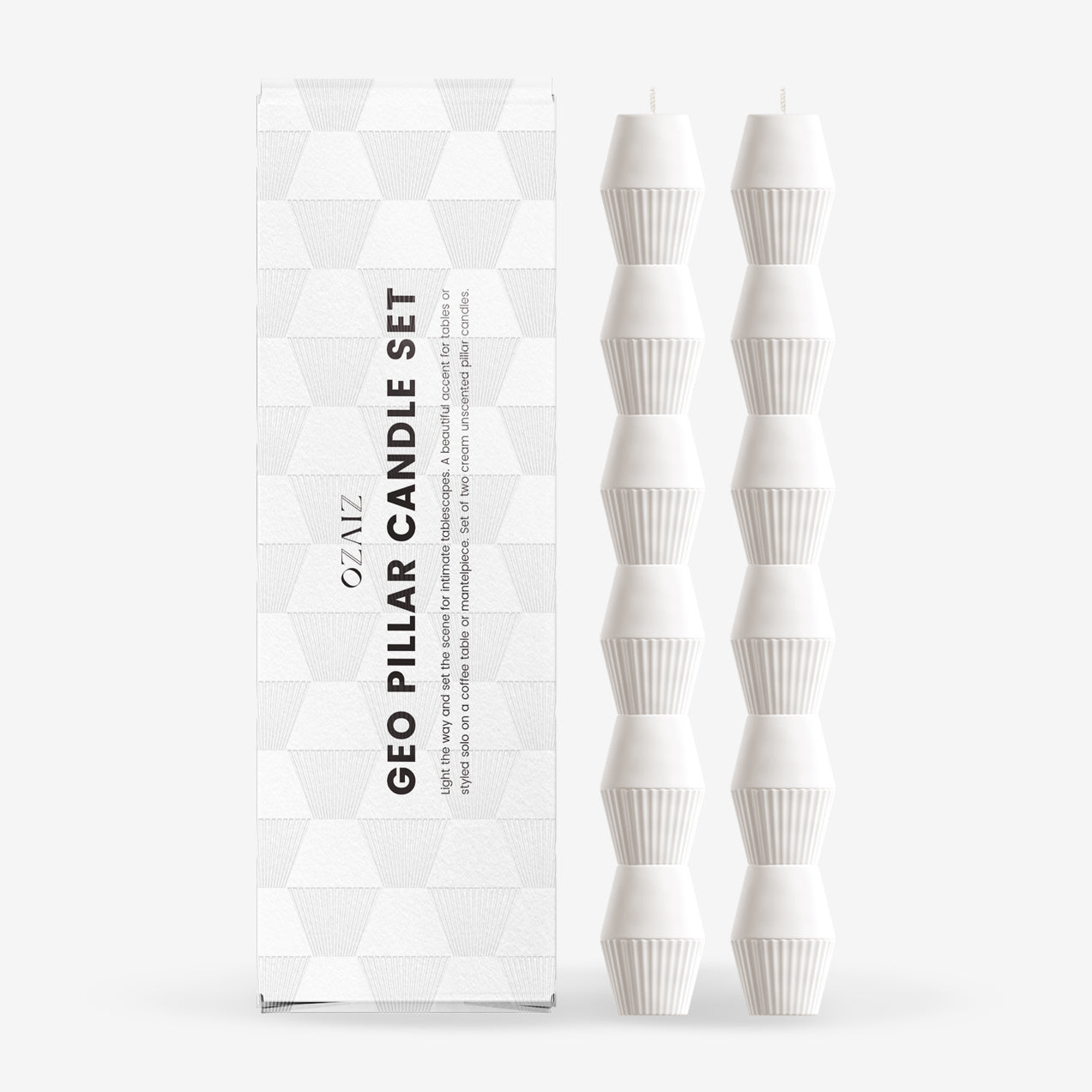 Set of white geo pillar candles with packaging on a white background