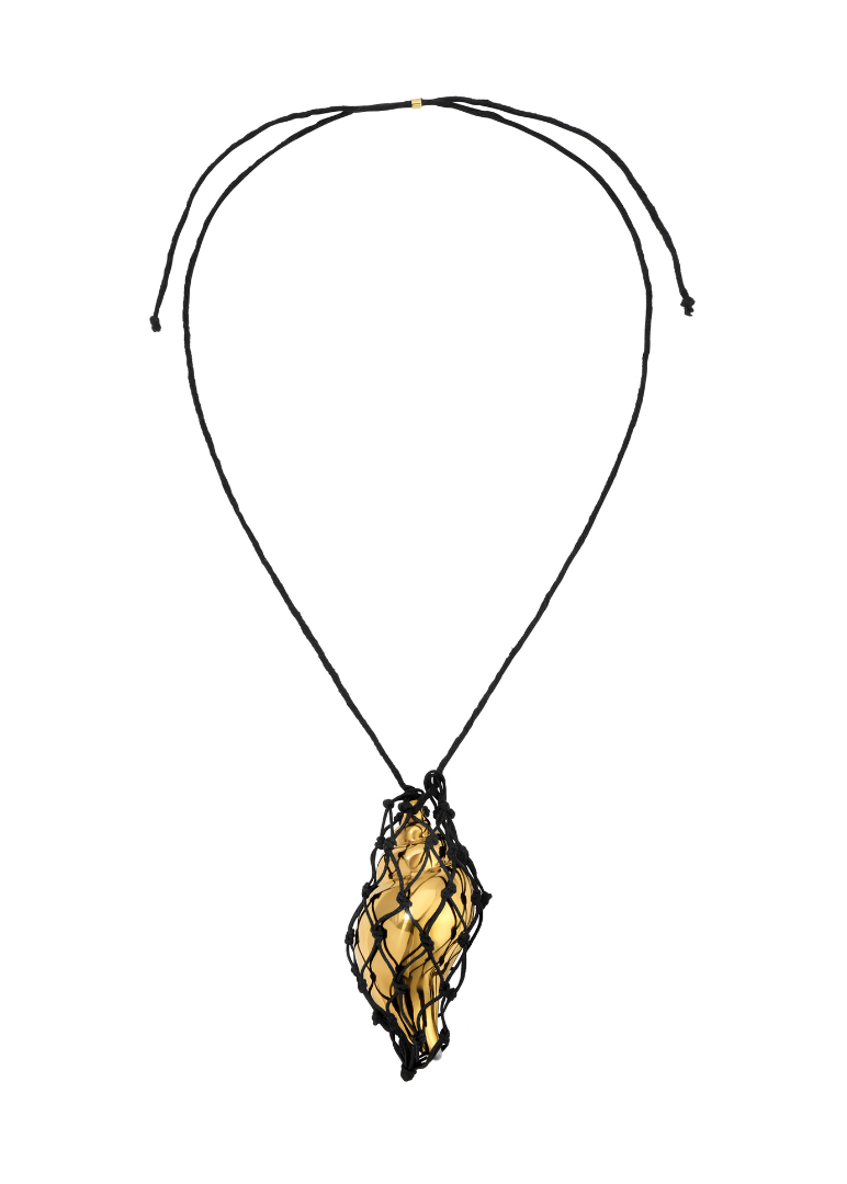 Cord necklace in black with a gold shell pendant on a white background