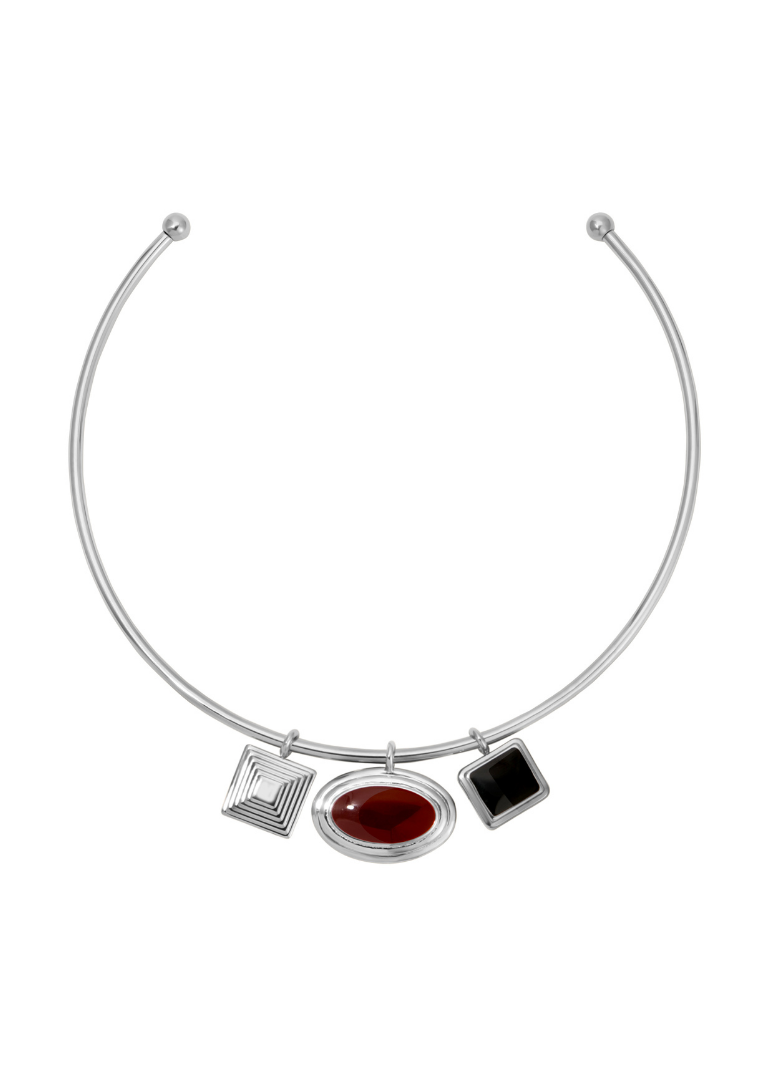 Silver necklace with three charms on a white background