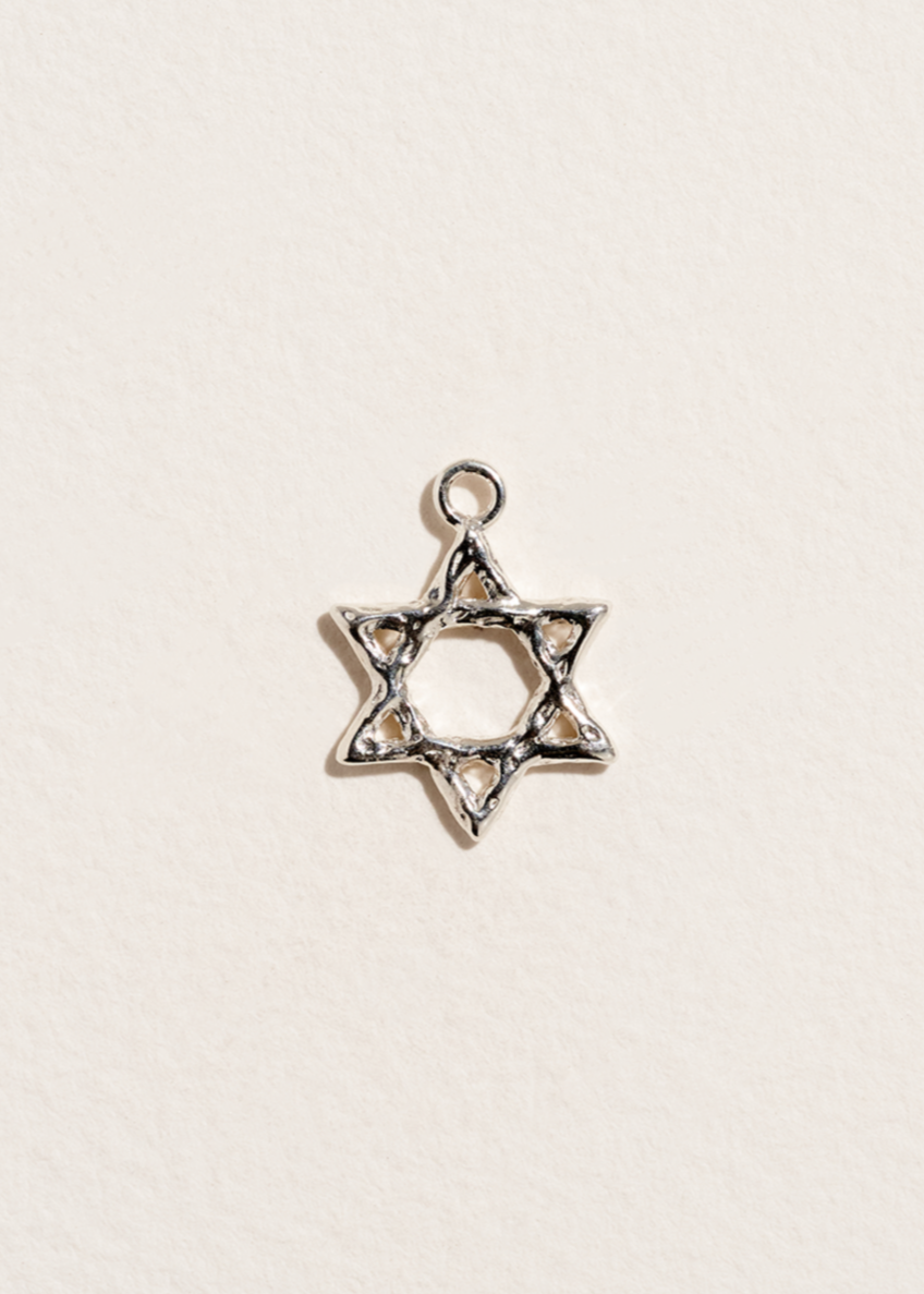 Sterling Silver Star of David pendant on a light beige background