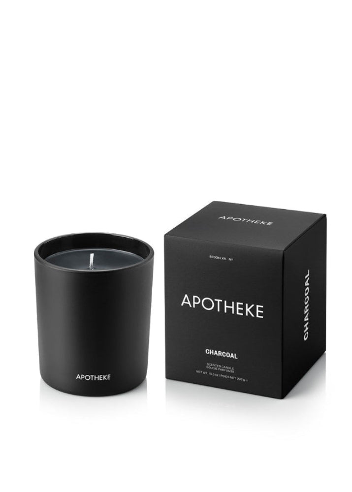 Black candle and packaging with 'Apotheke' branding on a white background