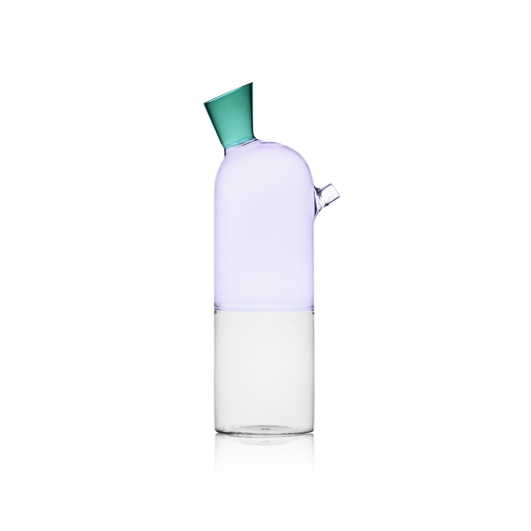 Clear carafe with a green lid on a white background