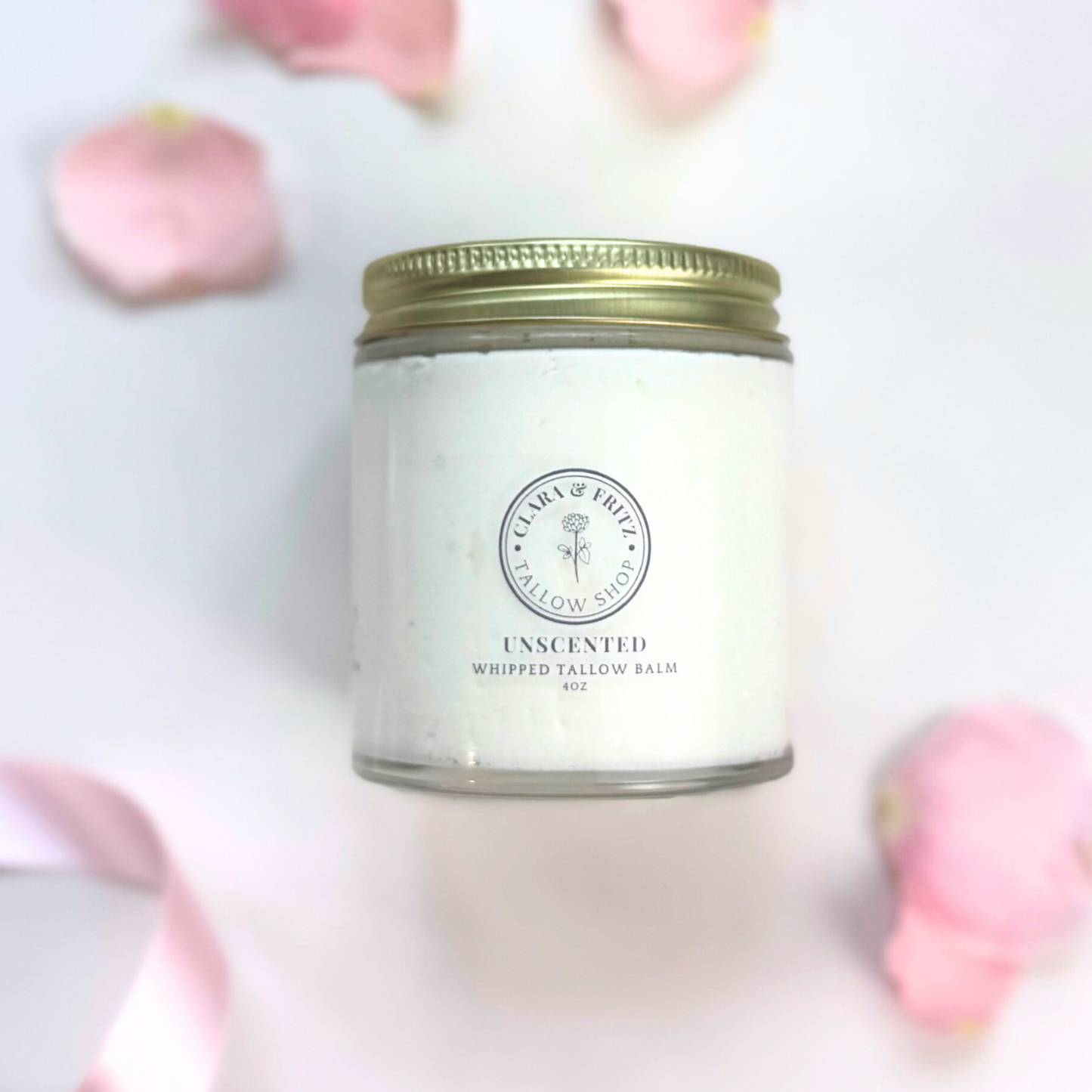 Side view of jar with Clara & Fritz branding, white content and pink petals 