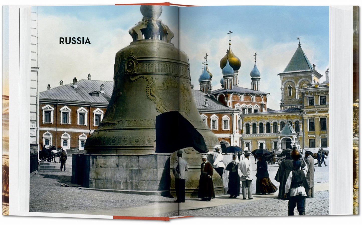 Book open to a page with a large bell and traditional Russian architecture.