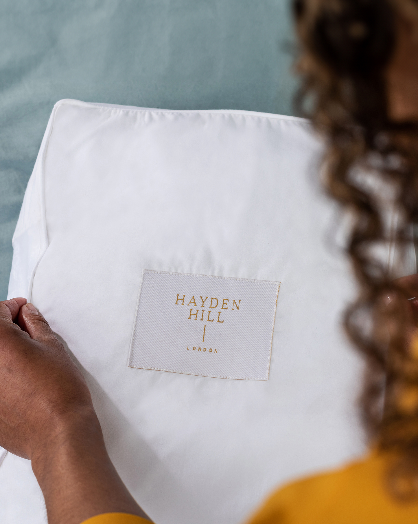 Closeup view of the Hayden Hill woven label on top of the cotton satchel. 