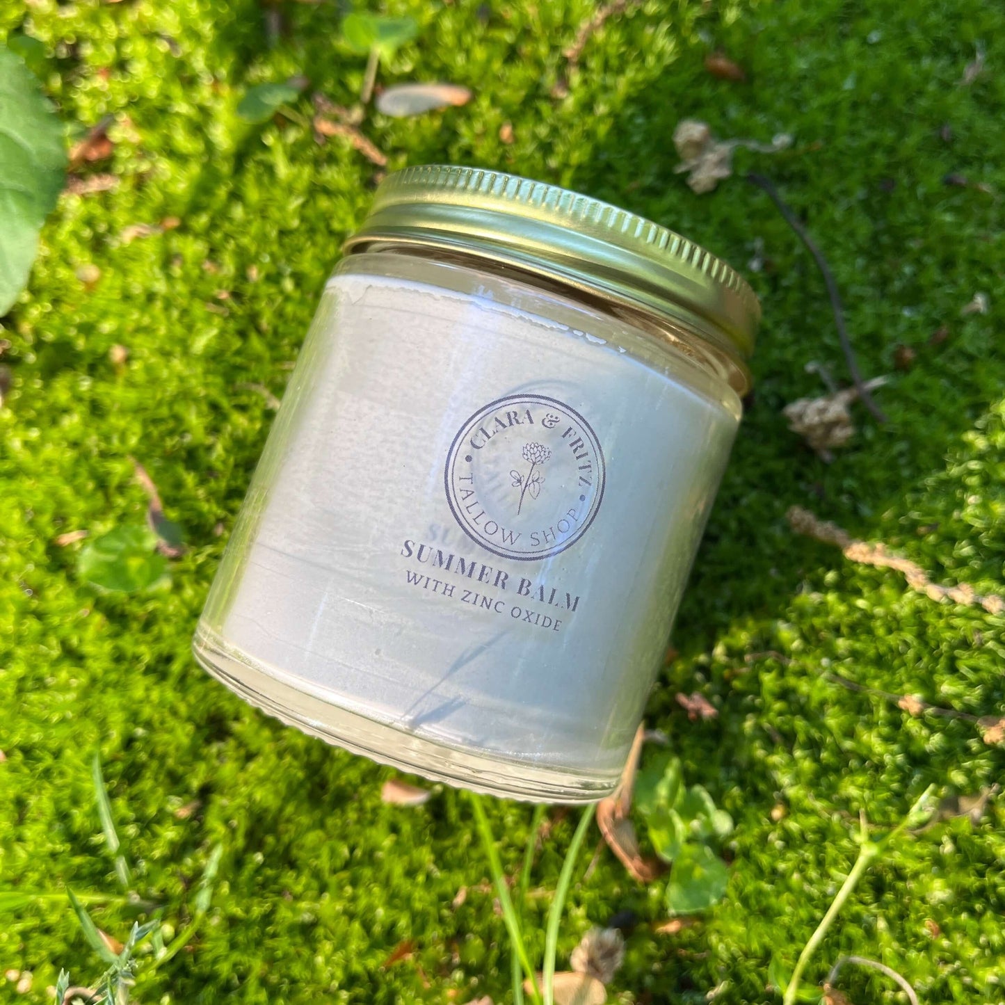 Jar of 'Summer Balm' on a grassy background