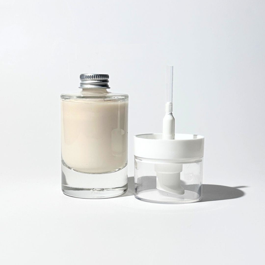 Glass bottle of anti-aging organic lotion with applicator pump