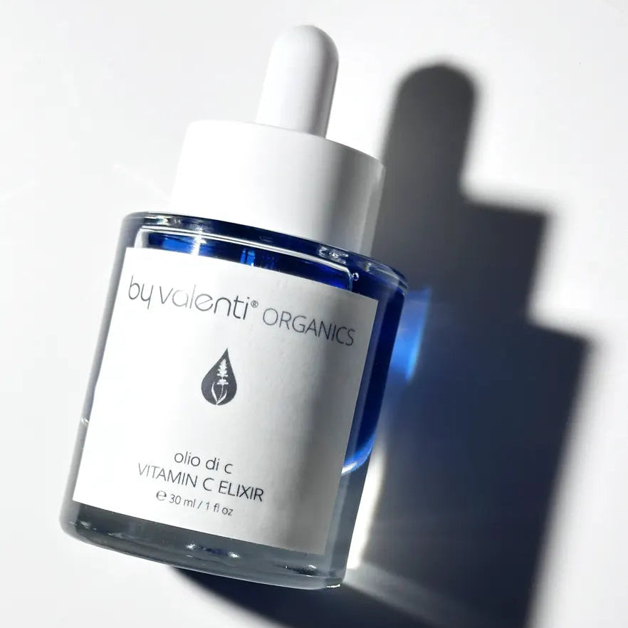 Vitamin C elixir bottle with dropper on a white background