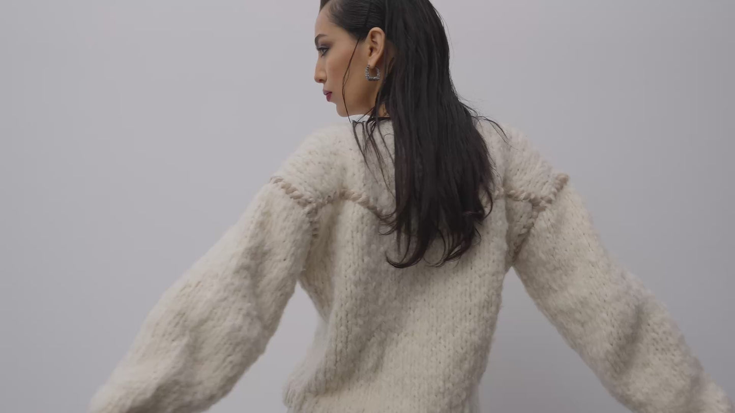 A visual presentation of the Santicler Fall 2025 collection: luxurious knitwear pieces in cashmere and cashmere blends, feminine dresses in floral cotton lace from Italy, corduroy skirts, pants and jackets in a palette of rich browns, sugary creams, and alomond beige.
