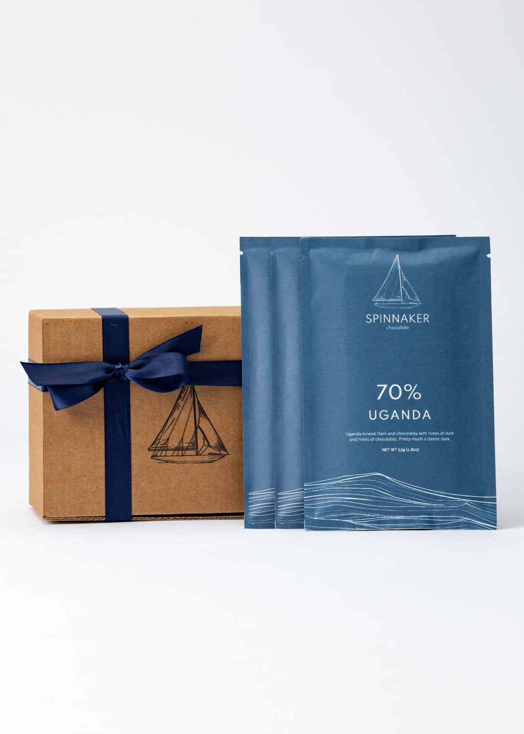 BlueSpinnaker chocolate packaging with a brown box and blue ribbon on a white background